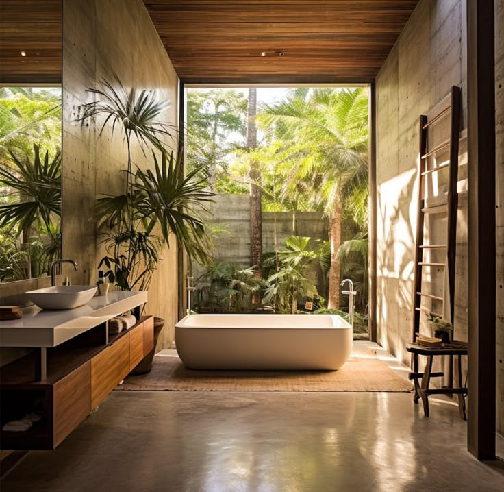 a bathroom with a large tub next to two sinks and plants in the window sill