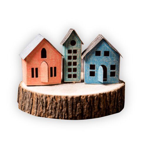 three small houses sitting on top of a tree stump