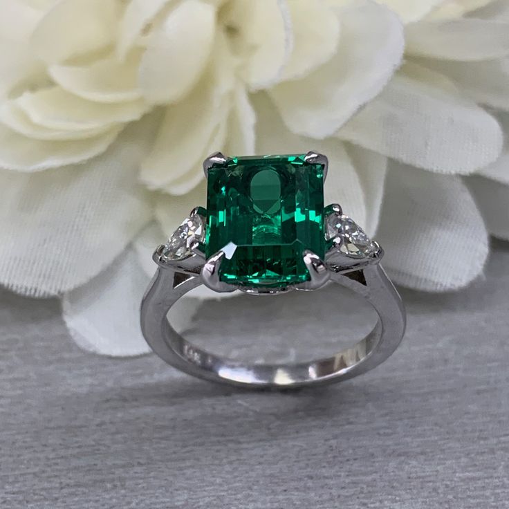 May Birthstone Ring, Emerald Cut Emerald Engagement Ring, Moissanite Ring, Three Stone Ring, Large Cocktail Ring, 14k White Gold Ring, 6722 #EmeraldRing #infinityjewelersusa #WeddingRing #BirthdayGift #EngagementRing #AnniversaryGift #CocktailRing #EmeraldCutEmerald #ThreeStoneRing #MoissaniteRing Gia Certified Diamond Gemstones For Anniversary, Gia Certified Emerald Cut Gemstones For Anniversary, Fine Jewelry Cushion Cut Gemstone With Center Stone, Cushion Cut Gemstones With Prong Setting, Platinum Green Rings For Anniversary, Green Platinum Anniversary Rings, Platinum Green Ring For Anniversary, Platinum Green Gemstone Rings, Green Gemstone Platinum Ring