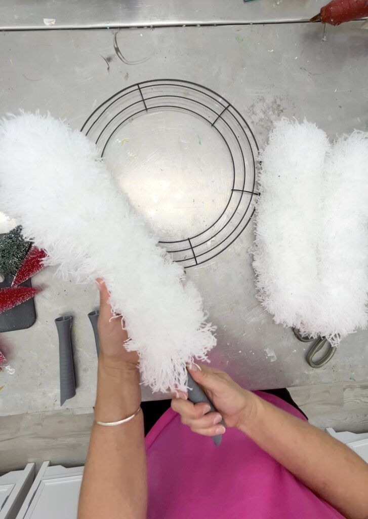 a woman is working on some white feathers