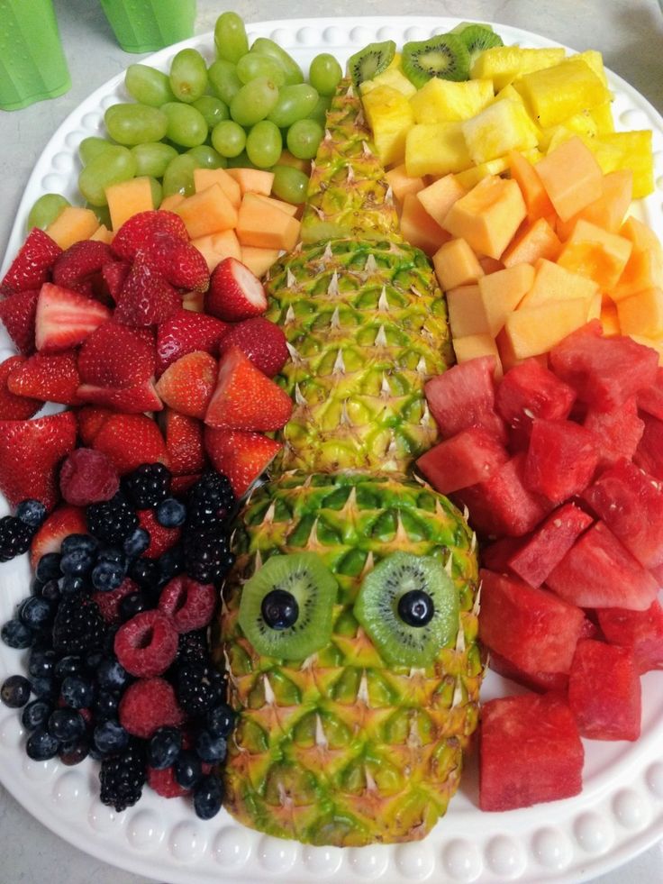 a white plate topped with fruits and vegetables