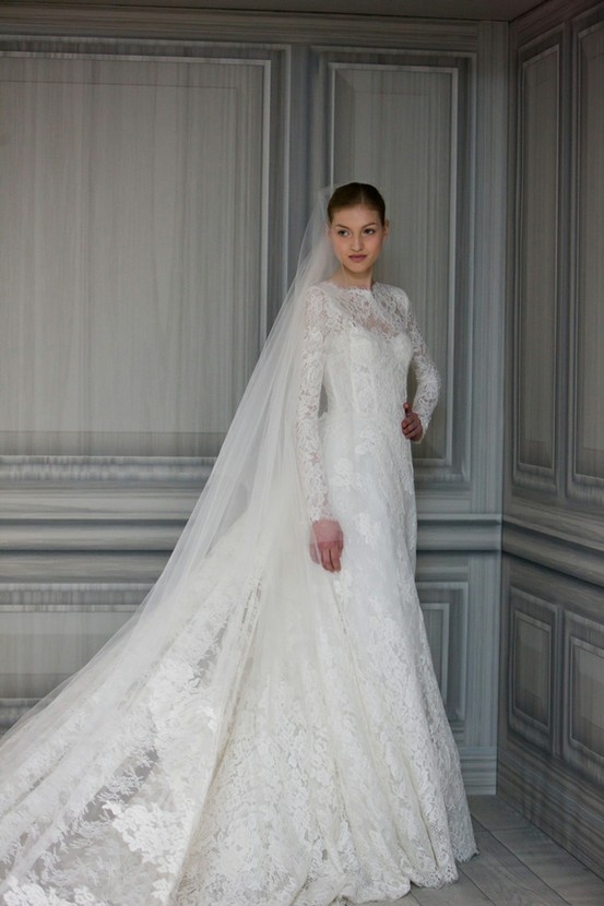 a woman in a white wedding gown and veil