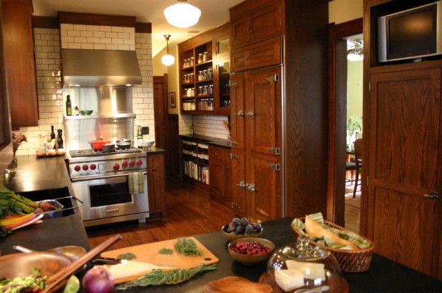 a kitchen filled with lots of wooden cabinets and counter top space next to an oven