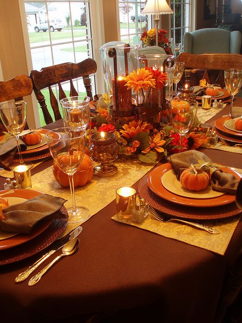 a dining room table is set with place settings for thanksgiving dinner guests to enjoy the meal