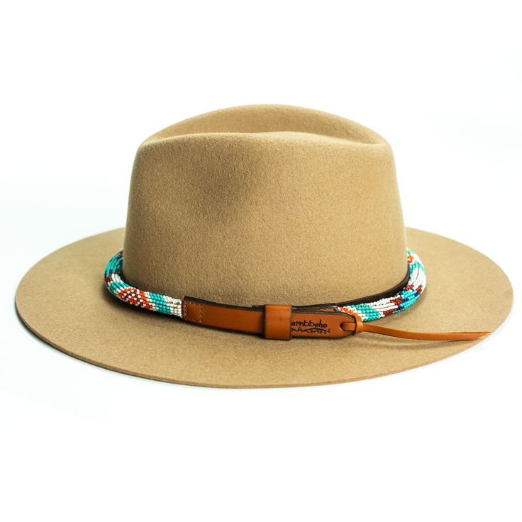 Price includes a Lola Sambboho hat & an Aztec rounded hatband. Save 10% with this bundle. Select hat size. Hatband is one size fits all. Hatband is removable. An iconic must-have Fedora hat that will never get out of fashion. Sambboho's Lola hat has a soft brim and indented crown. A chic piece to be worn at all seasons of the year. The timelessness chic and sophistication exuded by this hat make it a lifetime wardrobe investment you’ll never regret! Classic Fedora design in Sand color Trimme Bohemian Brown Hat For Outdoor, Bohemian Beige Panama Hat For Outdoor, Beige Bohemian Panama Hat For Outdoor, Brown Adjustable Sun Hat With Flat Crown, Adjustable Short Brim Hat For Ranch, Adjustable Felt Hat With Flat Crown For Outdoor, Bohemian Felt Hat With Curved Brim For Outdoor, Bohemian Fedora Felt Hat For Outdoor, Bohemian Short Brim Felt Hat For Outdoor