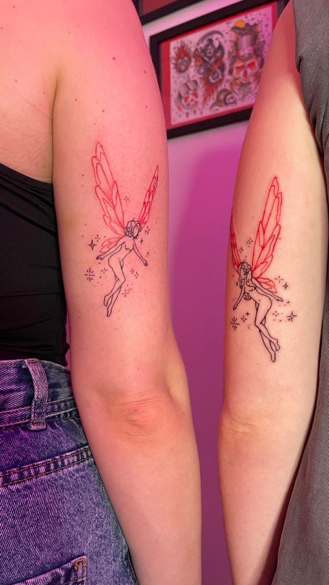 two girls with matching tattoos on their arms, one has a fairy tail and the other has a star