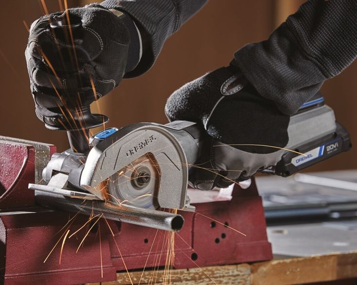 a person using a circular saw to cut wood with an angle grinder on a workbench