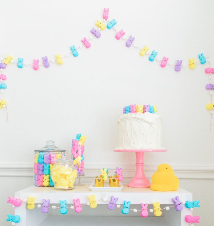 a table topped with a cake covered in frosting next to a yellow rubber duck