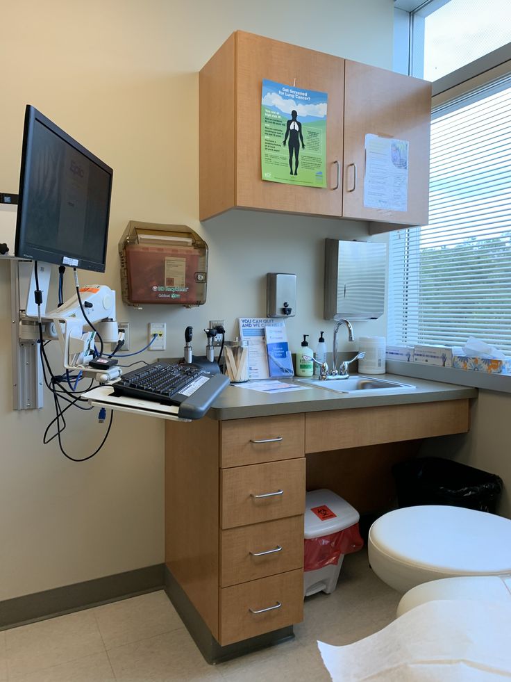 a medical room with a computer on the desk