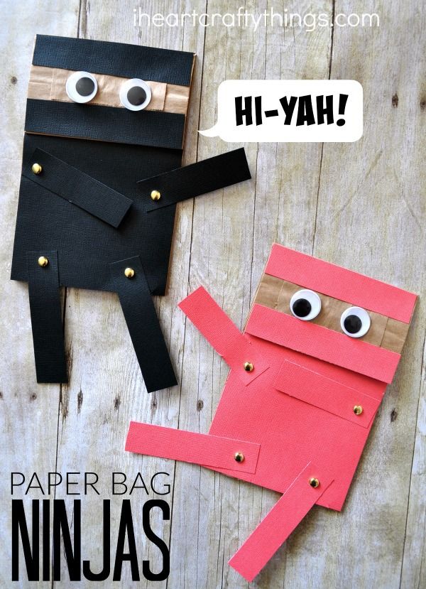 paper bag ninjas made out of construction paper and googly eyes, with the words hi - yah above them