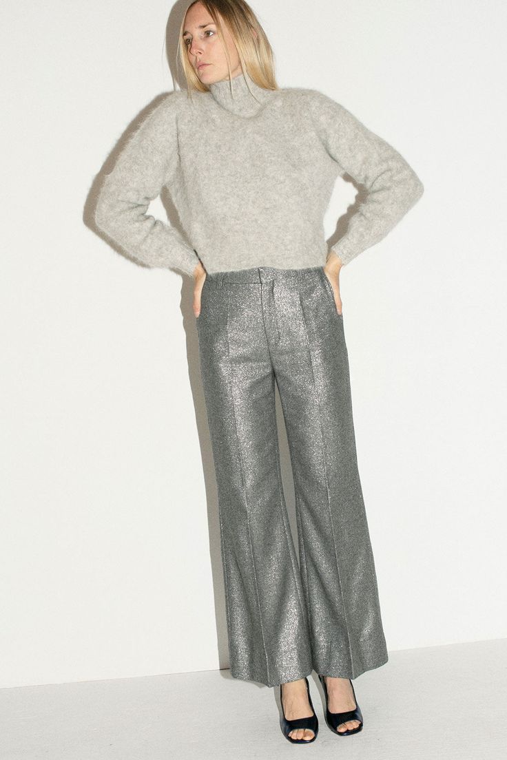 Shimmery trousers with a flared leg. Mid rise with a zip and hook and eye closure. Fabric is 60% recycled wool, 27% polyamide, 9% polyester, 4% other fibers. Ella is 6' tall, 36" bust, 27.5" waist, 38" hip, and is wearing a size S Grey Pants, Handmade Design, Sale Design, Modern Woman, Casual Pants, Mid Rise, Trousers, Sparkle, Wool