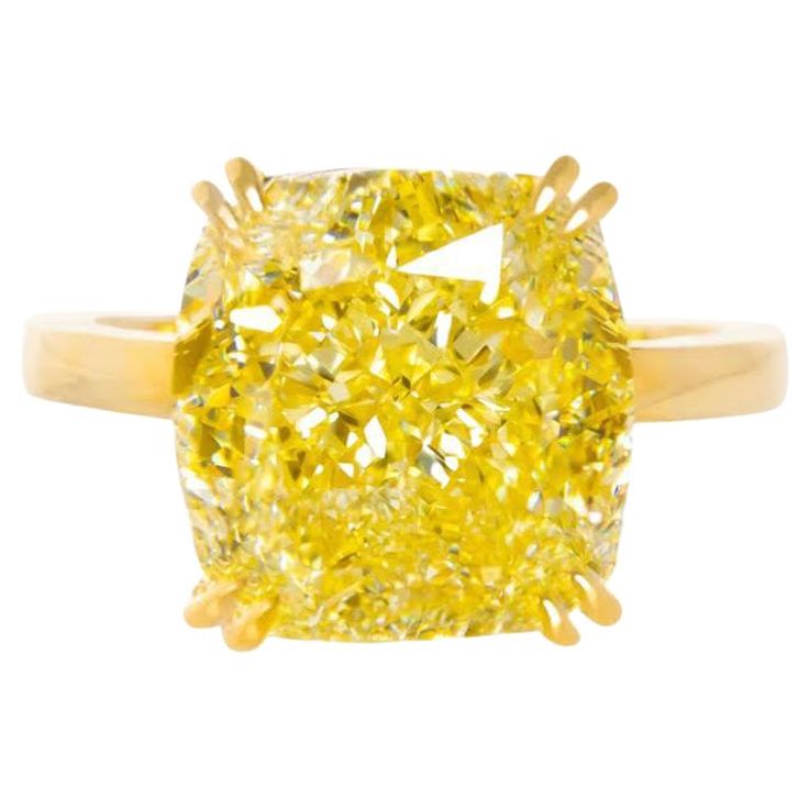 This stunning solitaire ring features a 5.01 carat fancy intense yellow Cushion Cut diamond, GIA certified for its exceptional quality. Crafted in 18K yellow gold, the warm hue of the setting beautifully complements the vibrant color of the diamond, creating a striking visual impact. A VS2 diamond with minor inclusions, which are hard to notice without magnification, ensuring high clarity and a dazzling shine. Its excellent polish enhances light reflection, ensuring a captivating display of bril Radiant Diamond Engagement Rings, Radiant Diamond Rings, Radiant Cut Diamond Ring, Yellow Diamonds Engagement, Yellow Diamond Engagement Ring, Yellow Diamond Rings, Fancy Yellow Diamond, Platinum Diamond Rings, Modern Engagement Rings