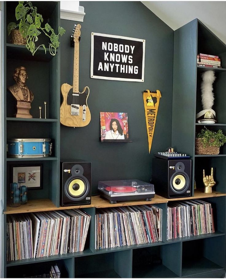 a room with many bookshelves and various musical instruments on top of each shelf