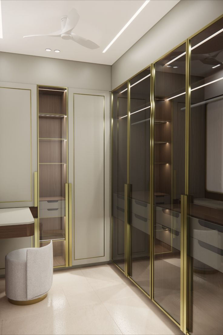 an empty room with glass doors and gold trim