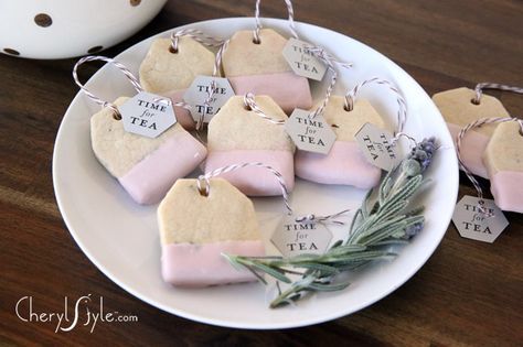 some tea bags are sitting on a plate with lavender flowers and tags attached to them