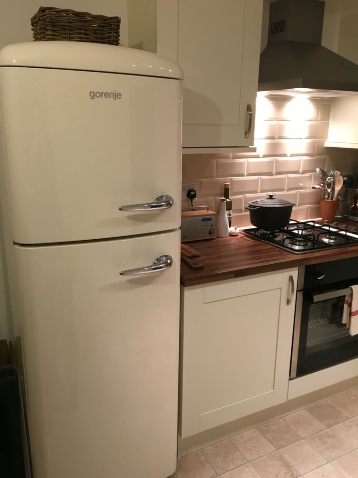 a white refrigerator freezer sitting inside of a kitchen next to a stove top oven