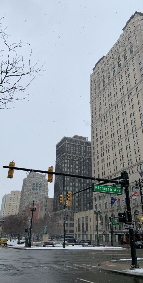 an intersection with traffic lights and street signs in the middle of snow covered city streets