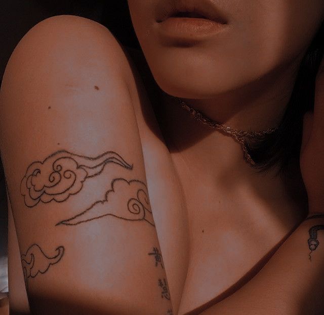 a woman with a tattoo on her arm