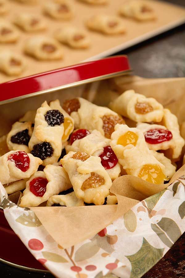 a red tray filled with cookies covered in fruit