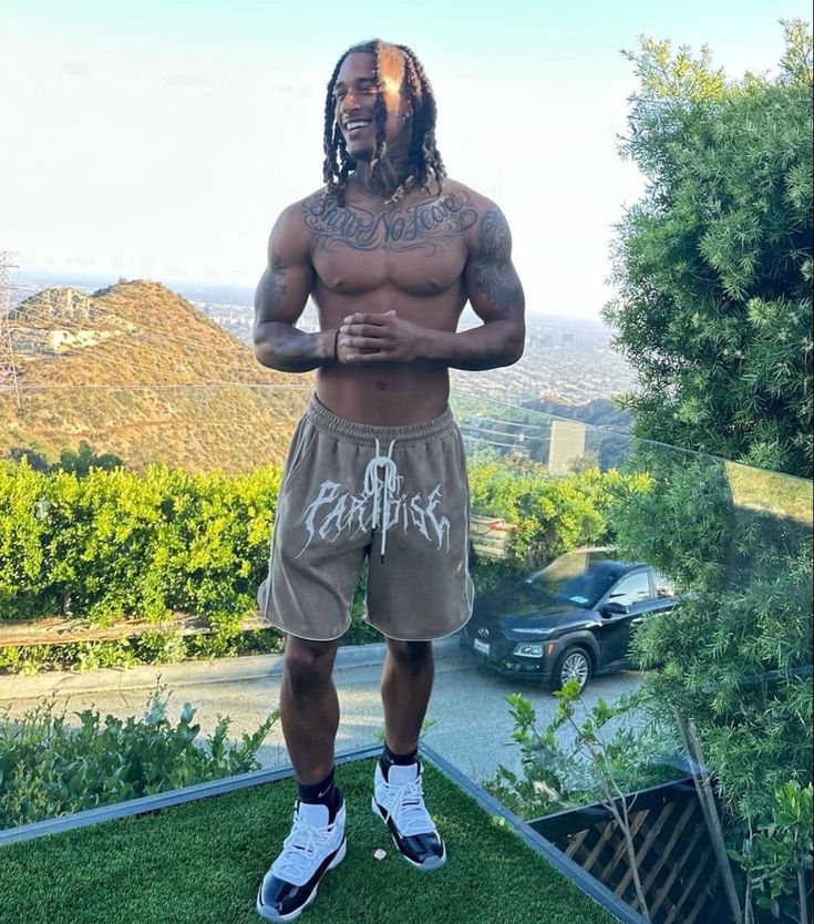 a man standing on top of a lush green field