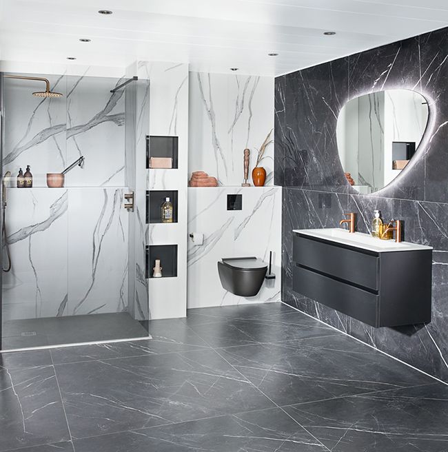 a bathroom with black and white marble walls