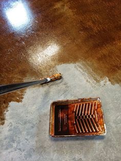 a floor grate with a brush on it and some water coming out of it