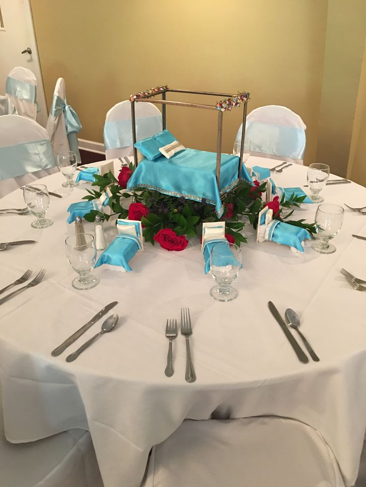 the table is set with silverware and blue napkins for an elegant wedding reception