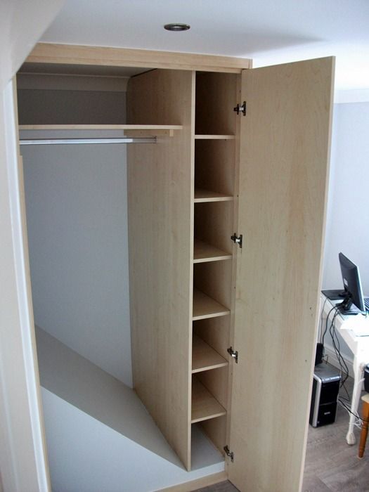 an open closet in the corner of a room