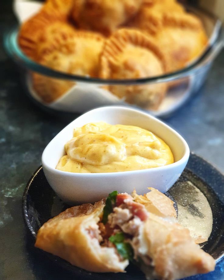 some food is sitting on a plate and in bowls next to other foods that are on the table