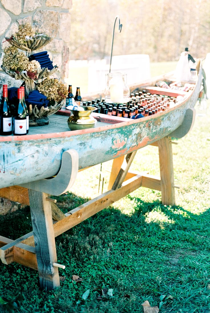 a picnic table with wine bottles and snacks on it