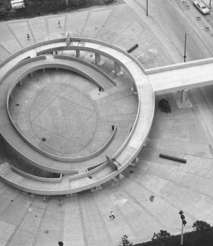 an aerial view of a circular building in the middle of a city