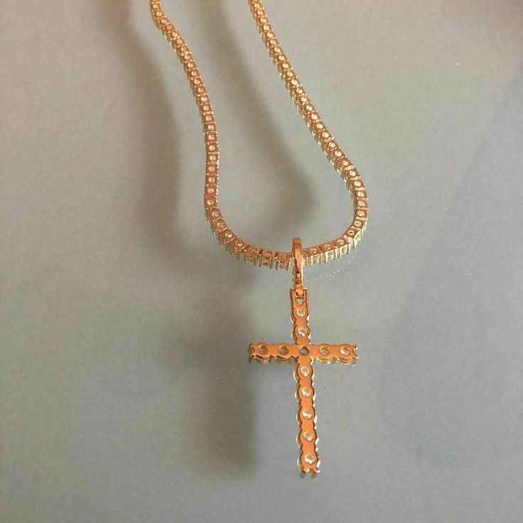 Gorgeous Mens Cross on tennis chain.

Man made diamonds
14k gold 5x electroplated over solid 925 sterling silver! Will NEVER tarnish or change colors

Chain is 3mm wide and we have all lengths from 18-30"
Chain weighs 30-40 grams depending on length an is 30-40 carats 

Pendant is about 5 grams and has 5 carats...measures 1" by 1.75"
 
This is truly a stunning piece and can be worn as a short choker or a longer chain!
This would also look dope as a c Gold Rope Chain Jewelry, Gold Cuban Link Tennis Necklace For Gift, Gold Figaro Chain Jewelry For Streetwear, Streetwear Jewelry With Box Chain And Cuban Link, Gold Diamond Cut Sterling Silver Tennis Necklace, Gold Jewelry For Streetwear, Gold Diamond Tennis Necklace With Box Chain, Gold Cubic Zirconia Necklaces For Streetwear, Hallmarked Diamond White Cross Jewelry