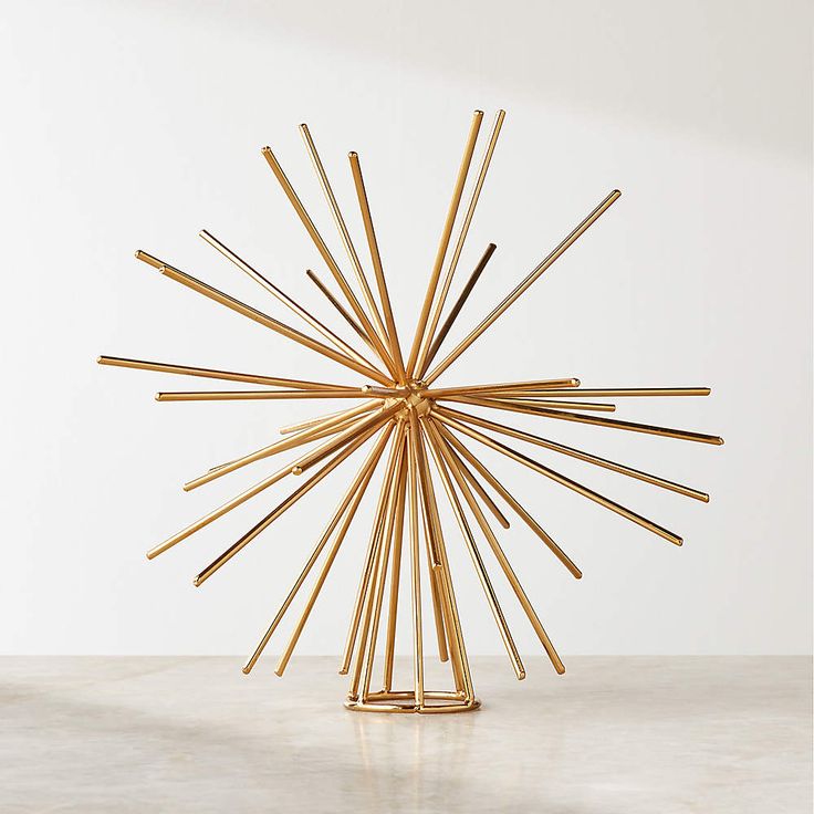 a sculpture made out of sticks sitting on top of a table