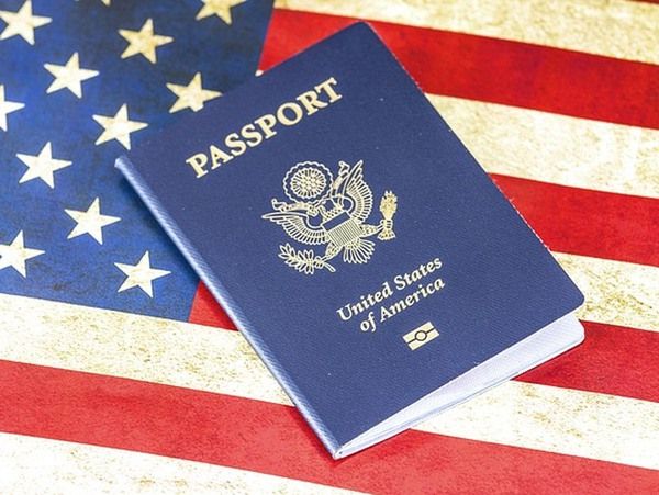 an american passport sitting on top of a flag