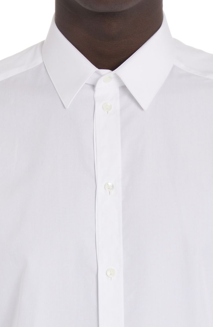 Channel a trim, tailored aesthetic in this cotton button-up shirt that features a crisp point collar and long sleeves. 30 1/2" length (size 40) Front button closure Point collar Long sleeves with button cuffs 100% cotton Dry clean or machine wash, line dry Made in Italy Men's Designer Clothing Slim Fit Button-up Dress Shirt, Slim Fit Collared Dress Shirt With Placket, Designer Button-up Business Shirt, Classic Shirt With Buttons And Lapel Collar, Slim Fit Collared Dress Shirt With Button Closure, Timeless Collared Shirt With Placket, Tailored Collared Shirt With Button Closure, Slim Fit Collared Dress Shirt With Button Cuffs, Business Casual Slim Fit Dress Shirt With Collar