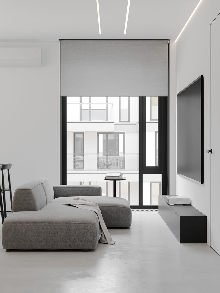 a modern living room with white walls and flooring is shown in black and white