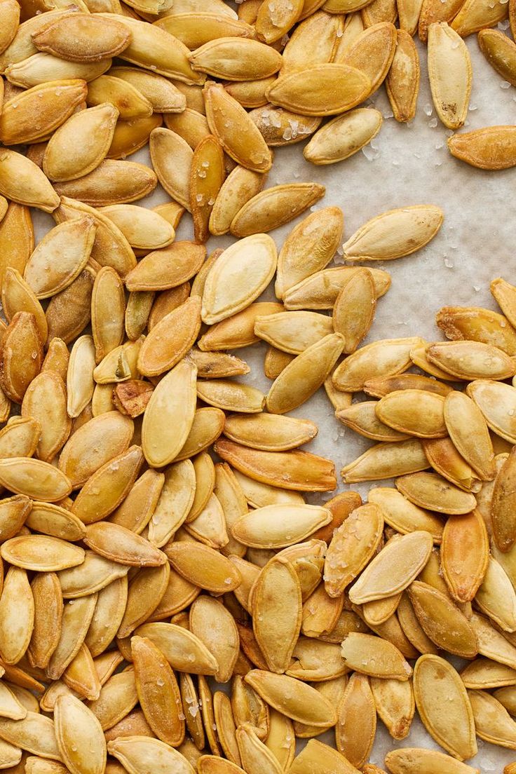 pumpkin seeds are shown on a sheet of paper