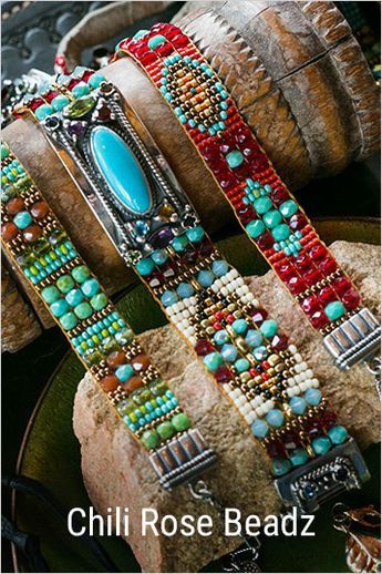 several bracelets with turquoise, red and green beads on top of each other in front of a rock