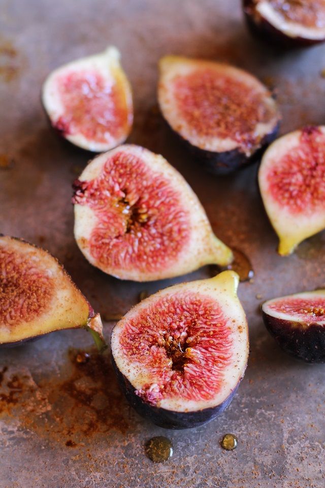 figs are cut in half on a cutting board