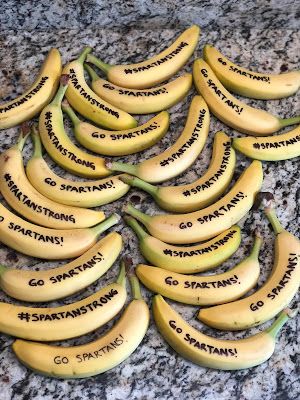 a bunch of bananas with words written on them sitting on a granite counter top next to each other