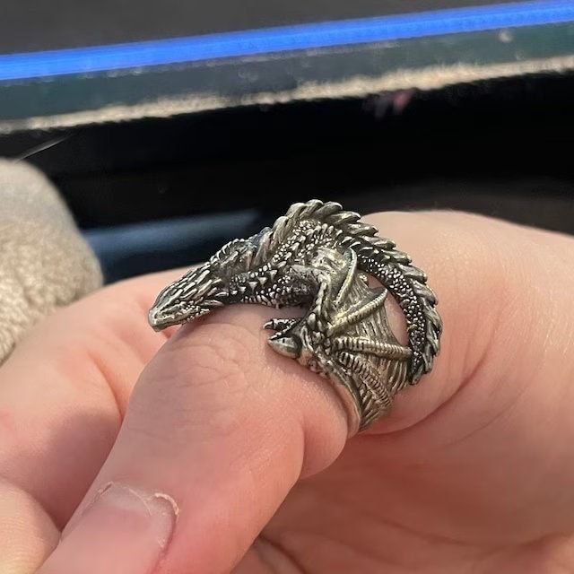 This beautiful Dragon ring is cast in 925 silver and shipped inside a beautiful stained wooden box. This ring is adjustable but please verify ring size so I can send you a ring that fits properly. Per the photos, some parts of this ring can be sharp and get caught on clothing. These rings are all handmade to order so each ring may have slight differences. Handmade in the USA of 925 silver. Also available in 24k gold plated! This is pure 24k gold that is plated to a thickness of 1 micron. minimum jewelry standard is 0.5 microns so I do double for longevity. Check out my YouTube channel for how the process works. Please verify ring size before ordering. Resizing is not possible for custom rings. Returns will only be accepted within 7 days of receipt and with receipt of the original price in Sea Rings, Fantasy Ring, Flying Dragon, Dragon Ring, Beautiful Dragon, Train Your Dragon, Mother Of Dragons, Men's Jewelry Rings, How To Train