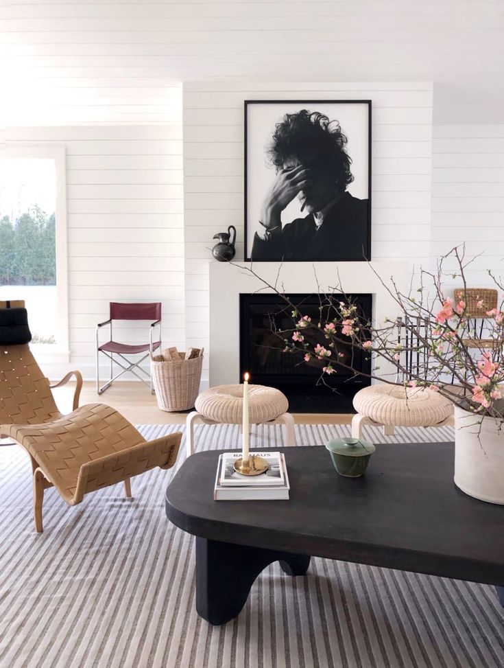 a living room filled with furniture and a fire place in the middle of a room