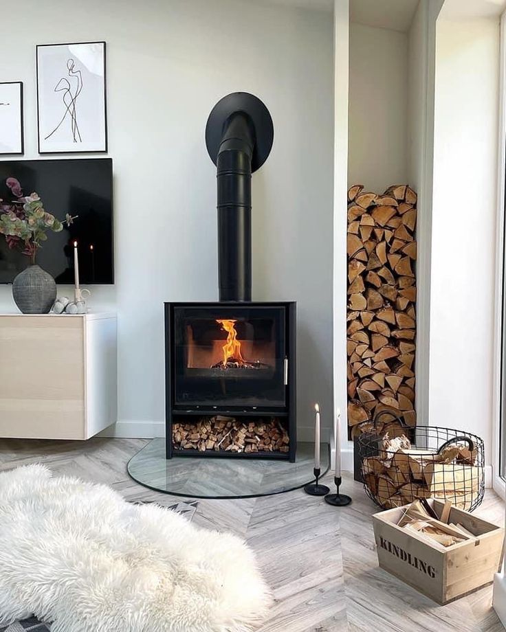 a living room filled with furniture and a fire place in the middle of the room