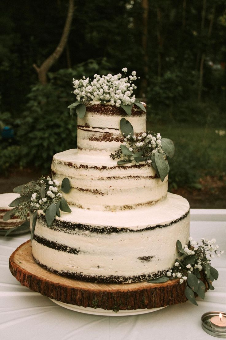 a wedding cake with white flowers and greenery