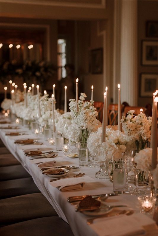 a long table with candles and flowers on it