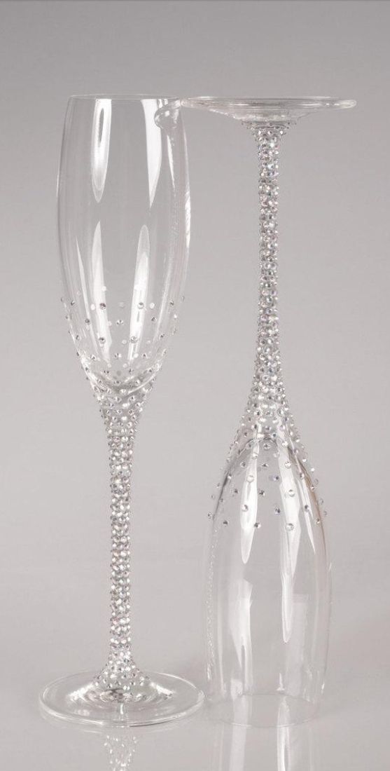 two crystal wine glasses sitting next to each other