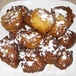 powdered sugar covered pastries on a white plate