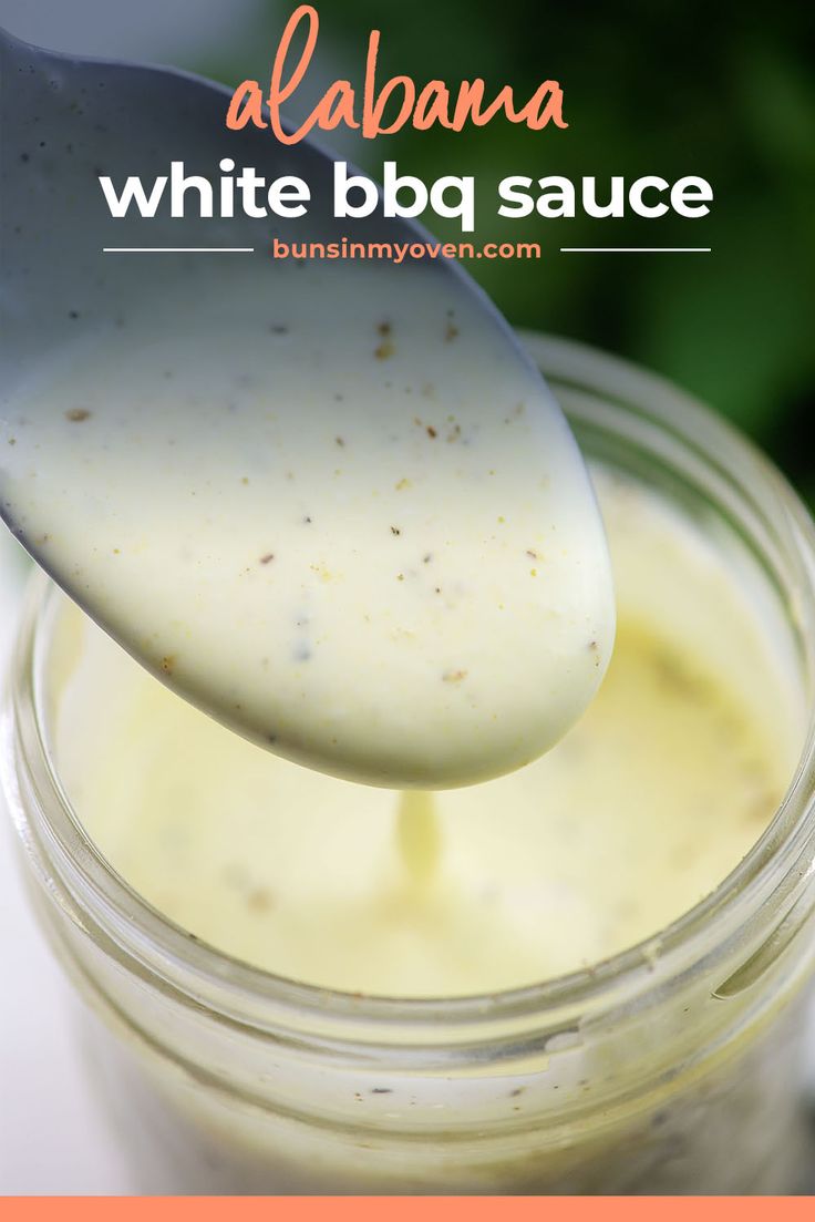 a spoon full of white bbq sauce in a mason jar with text overlay