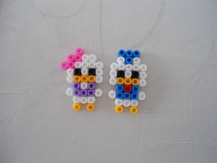 two small beads are made to look like sheeps with different colors and shapes on them