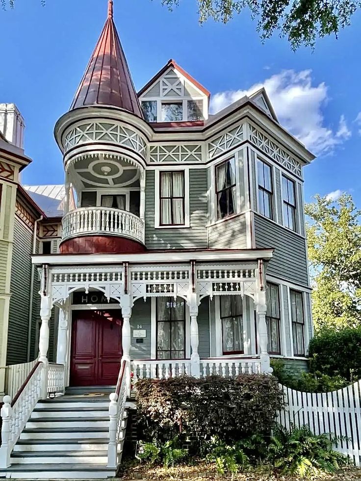 an old victorian style house with a red door